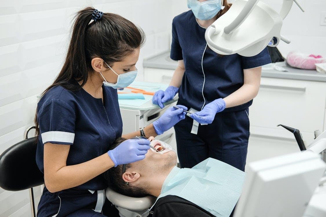 Oral Surgeon Conducting a Dental Exam